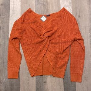 Knotted orange v-neck knitted sweater.